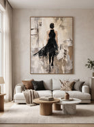 Abstract woman in black painting displayed in a modern living room with warm neutral decor and contemporary furnishings.