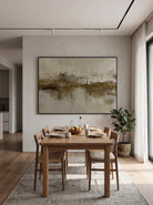 Large horizontal textured olive and taupe waterscape wall art displayed on a minimalist open-concept dining room wall