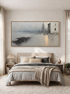 Muted grey and white cottage landscape painting by Evelyn Li hanging above bed in serene neutral bedroom