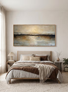 Muted gold and charcoal horizon canvas wall art by Evelyn Li hanging above bed in warm neutral bedroom