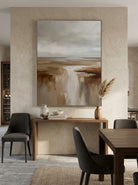 Oversized vertical earthy textured canvas wall art displayed on a minimalist open-concept dining room wall