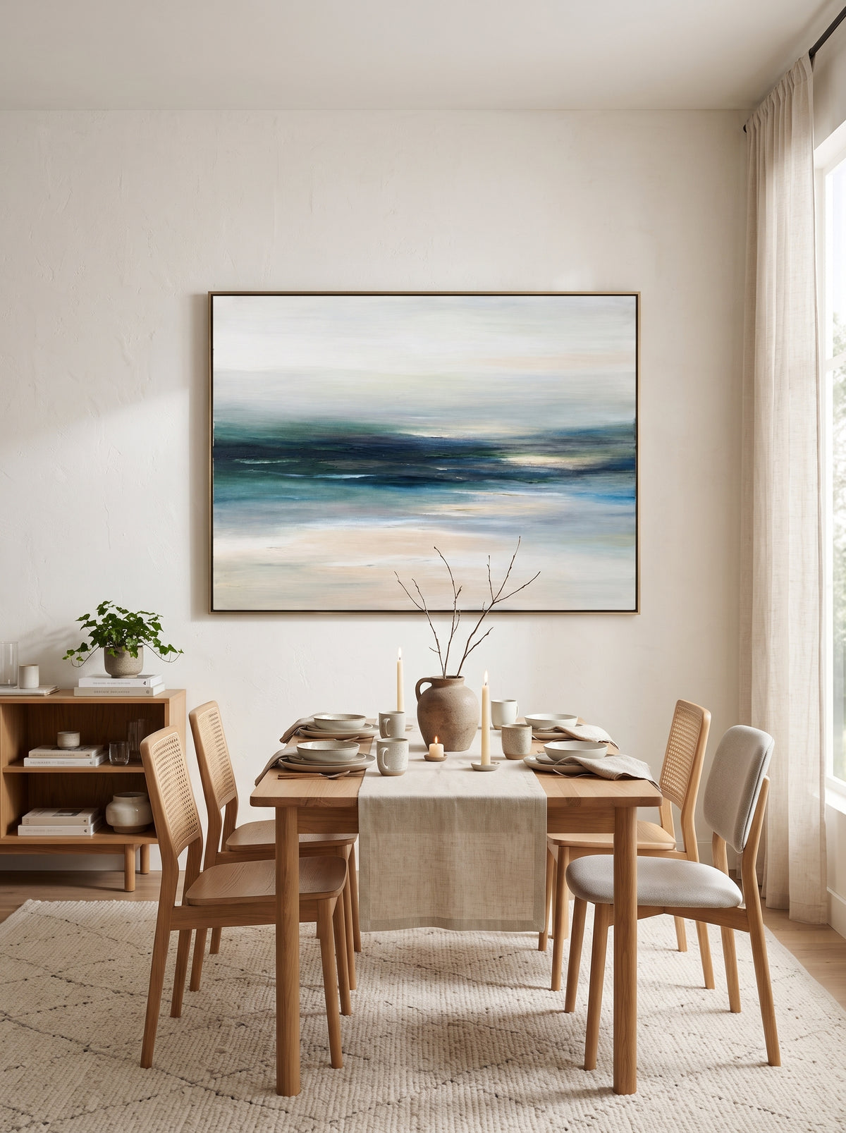 Framed horizontal modern marine horizon artwork displayed in open-concept dining room with wood furniture