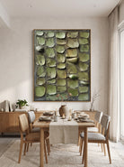Framed vertical earthy green textured wall decor mounted in open-concept dining room with natural wood accents