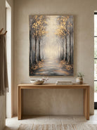 Framed textured golden woodland path painting placed over a modern wooden console table in an entryway
