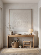 Architectural textured white geometric canvas painting mounted above modern entryway console table