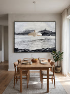 Large horizontal black and white coastal mountain textured wall art displayed on an open-concept dining room wall
