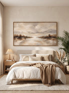 Calming neutral misty water and sky horizon artwork by Evelyn Li hanging above bed in serene bedroom