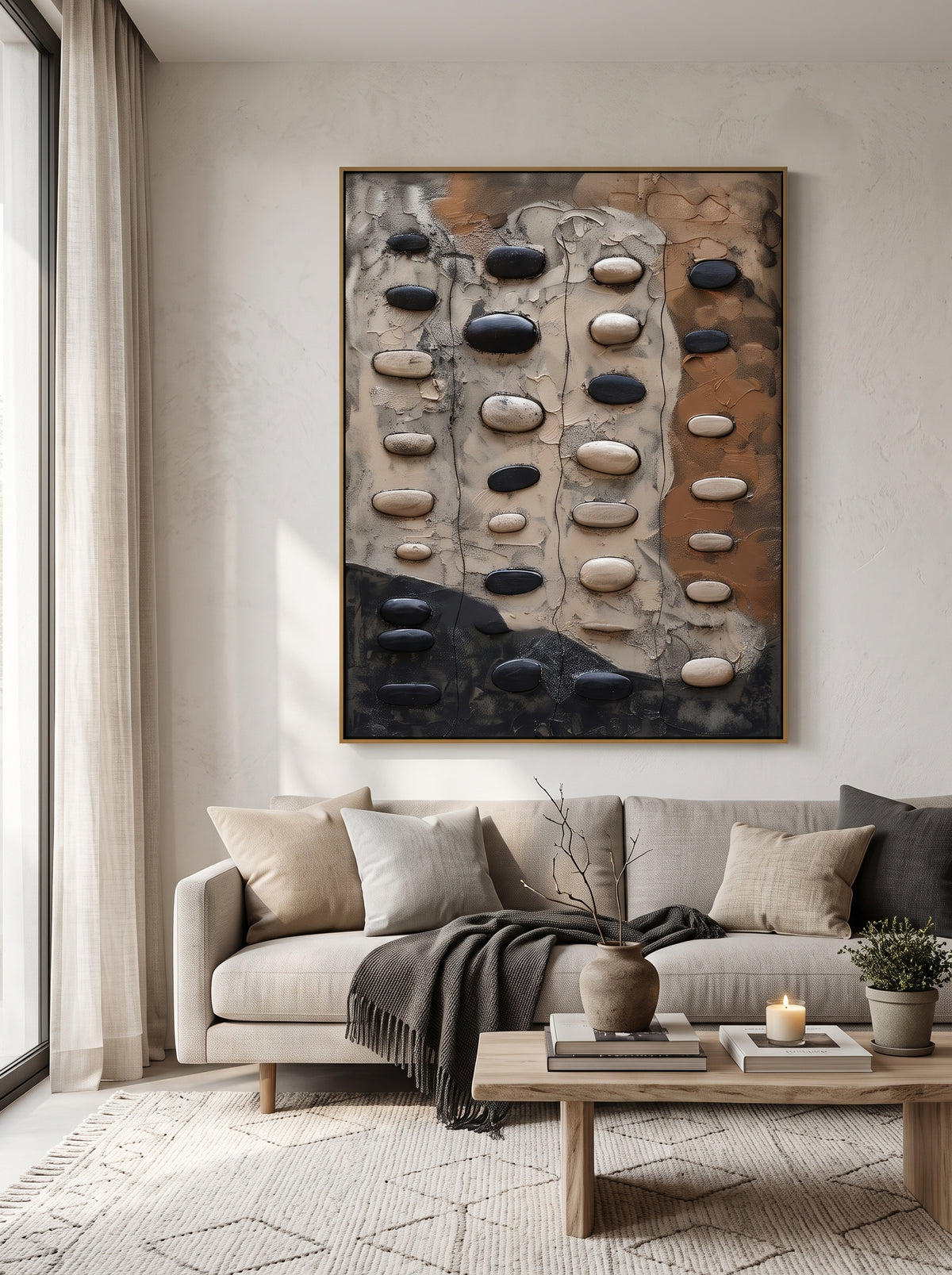 Large vertical earth-tone 3D stone relief canvas artwork displayed next to modern neutral sofa in minimalist living room