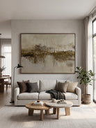 Oversized horizontal earthy olive green and beige abstract landscape painting mounted above a modern neutral sofa