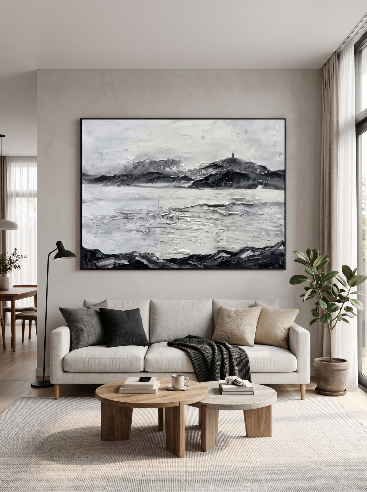 Oversized horizontal black and white textured mountain landscape painting mounted above a modern neutral sofa