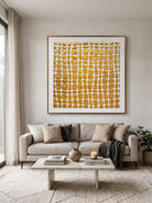 Large square metallic gold textured geometric canvas art above modern neutral sofa in luxury wabi-sabi living room