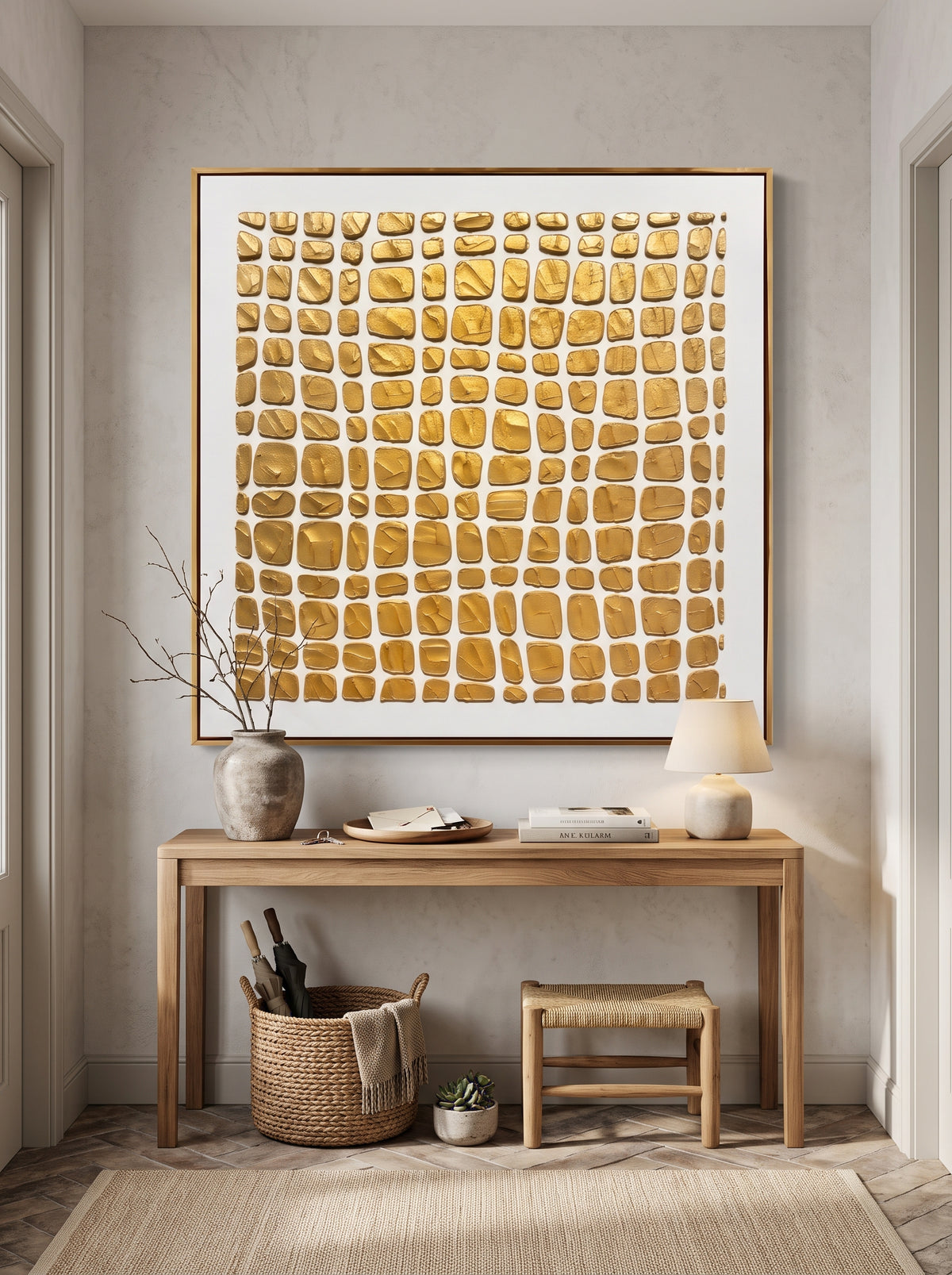 Sculptural warm gold relief canvas painting mounted above minimalist console table in Japandi entryway