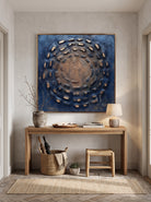 Earthy 3D circular impasto painting displayed above wooden console table in modern Japandi entryway
