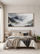 Calming black and white mountain valley wall art by Evelyn Li hanging above bed in contemporary bedroom