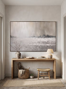 Minimalist horizontal textured snowy field canvas painting mounted above console table in entryway