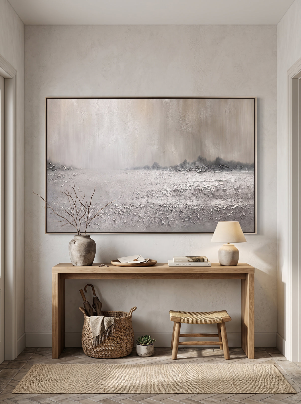Minimalist horizontal textured snowy field canvas painting mounted above console table in entryway