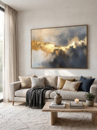 Large horizontal metallic gold textured abstract canvas wall art above modern sofa in luxury living room