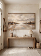 Warm beige and russet water reflection canvas painting mounted above minimalist console table in entryway