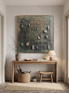 Earthy 3D impasto square relief painting mounted above wooden console table in modern Japandi entryway