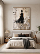 Textured female figure wall art with a black dress displayed in an elegant neutral modern bedroom.