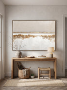 Warm ivory and metallic gold horizontal canvas painting mounted above console table in Japandi entryway