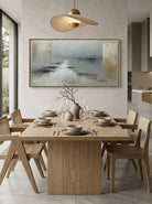 Muted grey coastal textured canvas wall art styled above an open concept dining room table