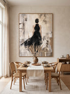 Hand-painted abstract woman in black wall art displayed in a contemporary open dining room with neutral decor.