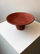 artisan ceramic geometric sculptures in matte rust red and black, modern minimalist architectural home decor on a white background.