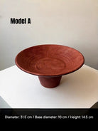 artisan ceramic geometric sculptures in matte rust red and black, modern minimalist architectural home decor on a white background.