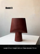 artisan ceramic geometric sculptures in matte rust red and black, modern minimalist architectural home decor on a white background.