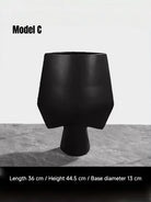 artisan ceramic geometric sculptures in matte rust red and black, modern minimalist architectural home decor on a white background.