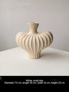 sculptural fluted ceramic vases in black, cream, and terracotta rust, organic heart-shaped silhouette, artistic home decor.