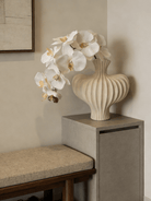 sculptural fluted ceramic vases in black, cream, and terracotta rust, organic heart-shaped silhouette, artistic home decor.