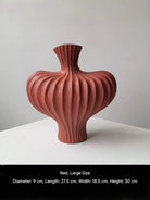 sculptural fluted ceramic vases in black, cream, and terracotta rust, organic heart-shaped silhouette, artistic home decor.