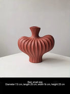 sculptural fluted ceramic vases in black, cream, and terracotta rust, organic heart-shaped silhouette, artistic home decor.