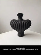 sculptural fluted ceramic vases in black, cream, and terracotta rust, organic heart-shaped silhouette, artistic home decor.