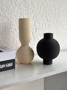 ribbed geometric ceramic vases in black, sand, and terracotta, minimalist organic pottery for shelf styling.