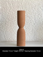 ribbed geometric ceramic vases in black, sand, and terracotta, minimalist organic pottery for shelf styling.