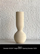 ribbed geometric ceramic vases in black, sand, and terracotta, minimalist organic pottery for shelf styling.