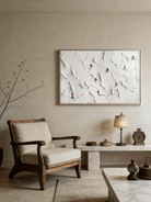 Close-up of large 3D textured painting by Lucien Hoffmann featuring tiny colorful skiers on a heavy white impasto snow mountain canvas.