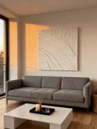 Textured plaster wall art displayed in contemporary living room, showcasing abstract canvas in modern home interior