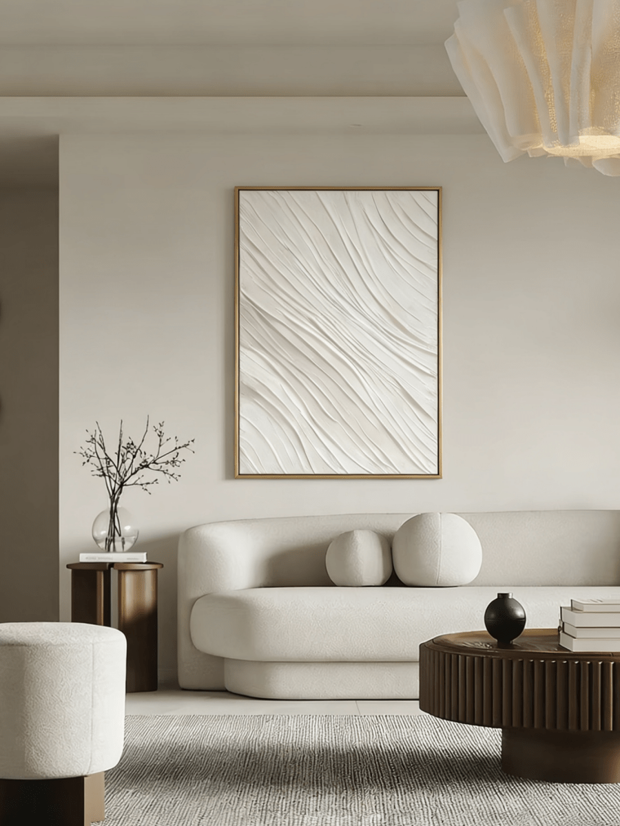 Close-up of the hand-painted white textured wall art featuring heavy impasto flowing waves in a slim gold floater frame.