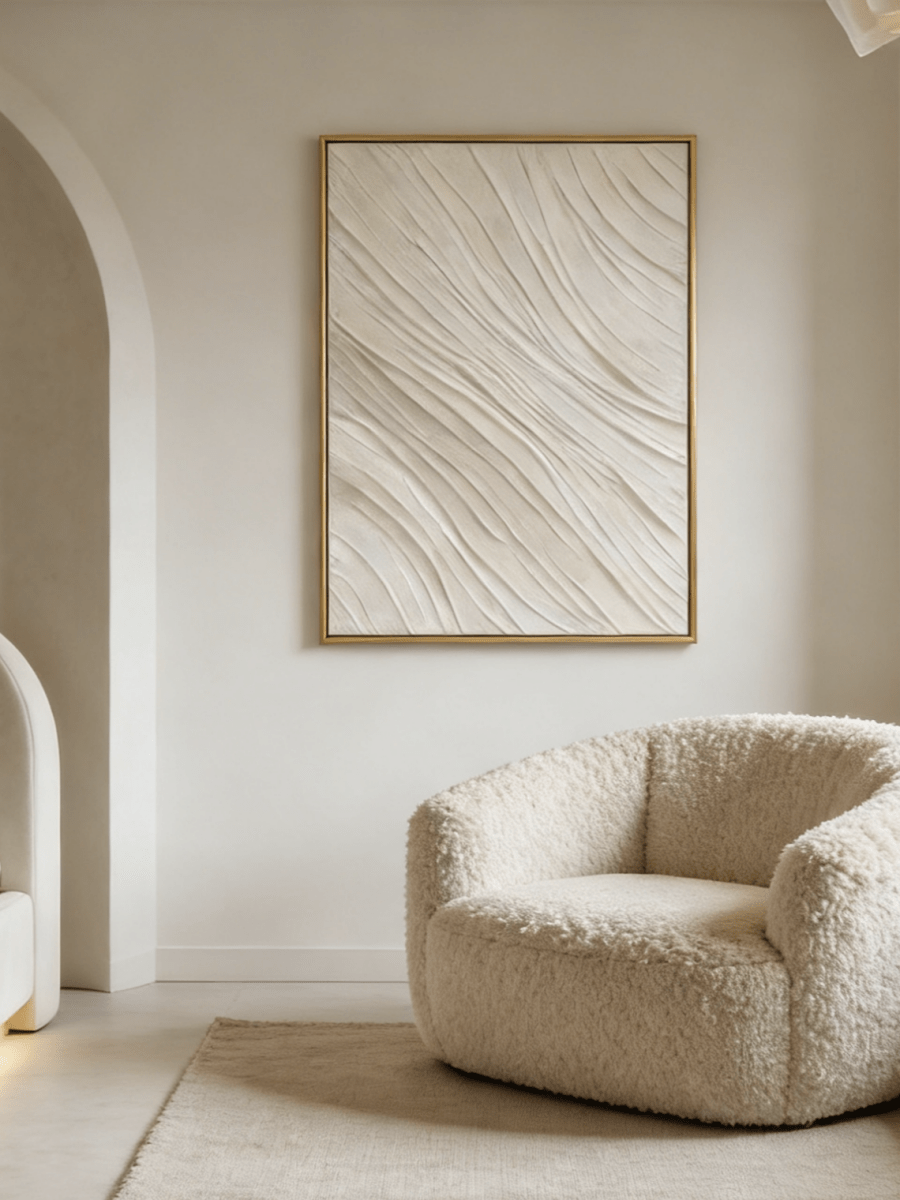 Close-up of the hand-painted white textured wall art featuring heavy impasto flowing waves in a slim gold floater frame.