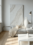 Textured plaster abstract wall art displayed in contemporary living room interior setting