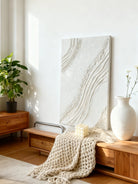 Textured plaster abstract wall art displayed in contemporary living room interior setting