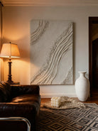 Textured plaster abstract wall art displayed in contemporary living room interior setting