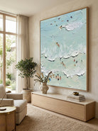 Hand-painted textured coastal surf wave wall art featuring ocean waves and surfers in soft aqua tones on canvas