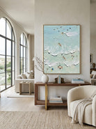 Hand-painted textured coastal surf wave wall art featuring ocean waves and surfers in soft aqua tones on canvas