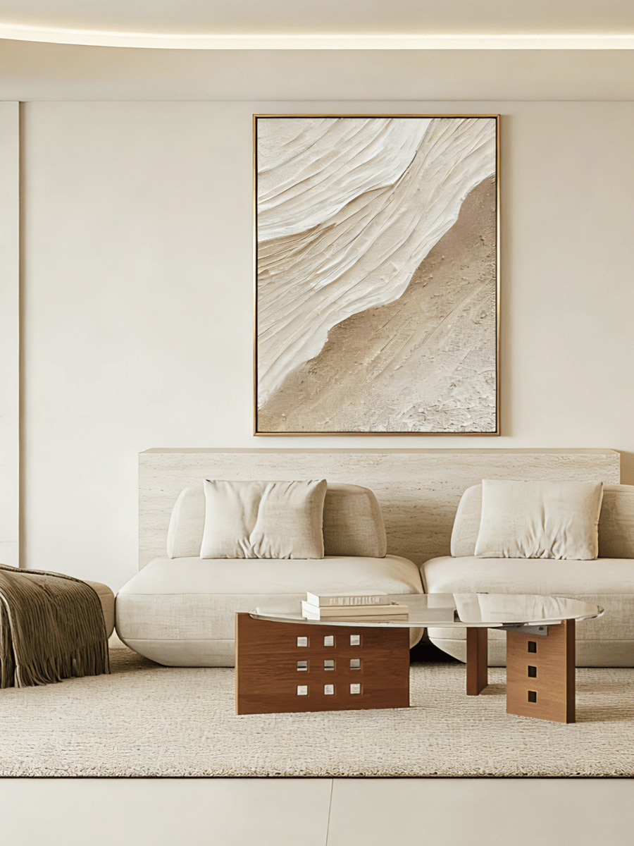 Large vertical 3D textured abstract painting with heavy sand-colored impasto ridges in a modern minimalist living room.