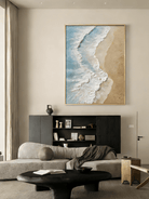 Large vertical 3D textured ocean wave painting featuring white impasto foam and turquoise water on a sandy beach background.